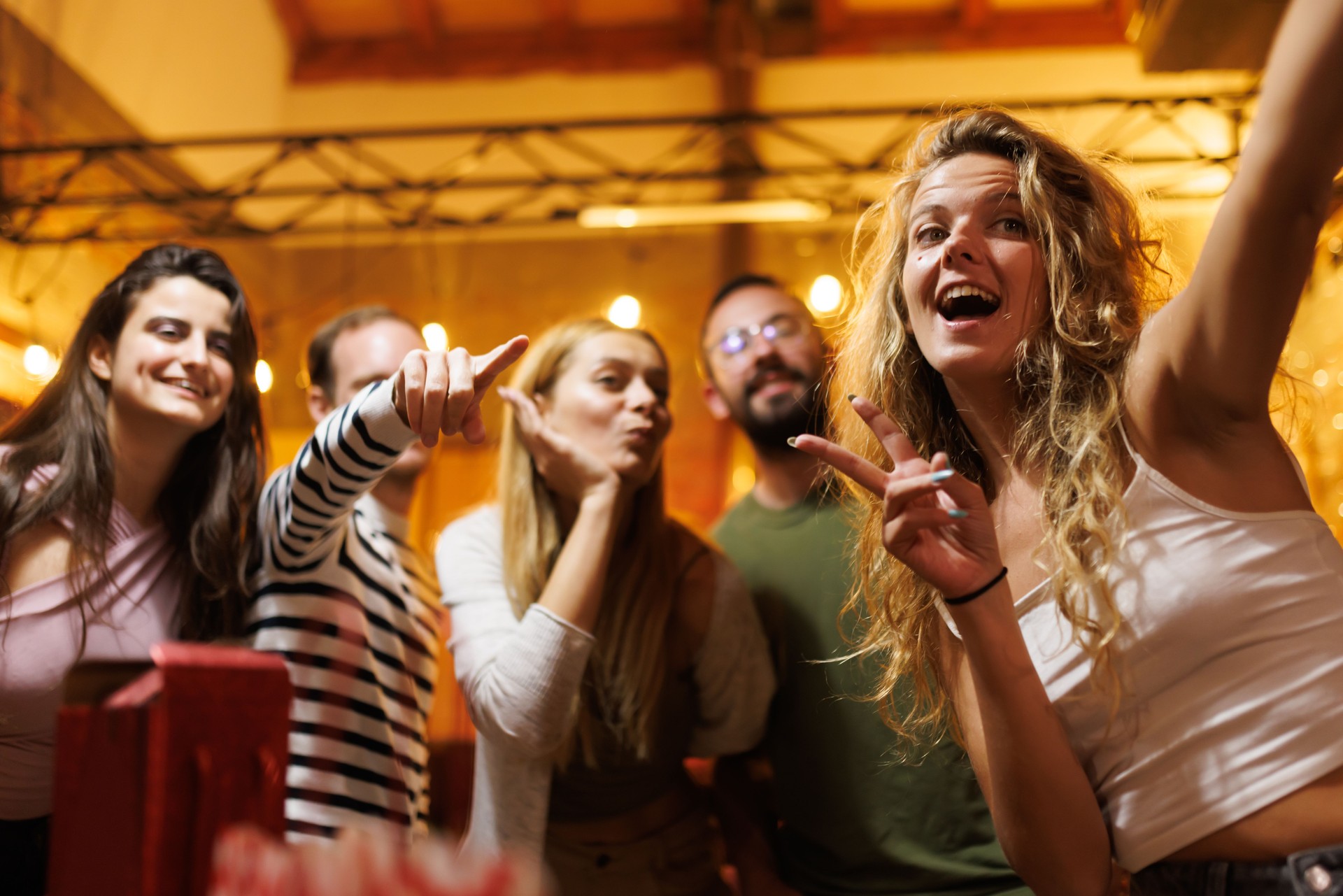 Group of friends enjoying a night out at a social gathering in a lively and festive atmosphere